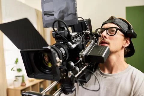 Man Operating Professional Cinema Camera on Video Production Set Stock Photos