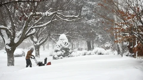 Man operating snow blower during a winter storm, Utah. Stock Footage 124333770
