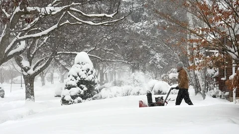 Man operating snow blower during a winter storm, Utah. Stock Footage 124334044