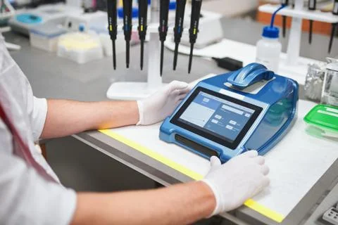 Man operating tester in laboratory Stock Photos