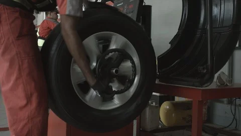 Man Operating a Tire Balance Machine Stock Footage 96185885