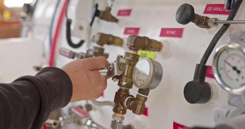 Man operating valves on hyperbaric chamber close up Stock Footage 275341329