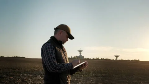 Man operator equipment tablet pc controls solar radio telescope antennas. Move Stock Footage 165371197