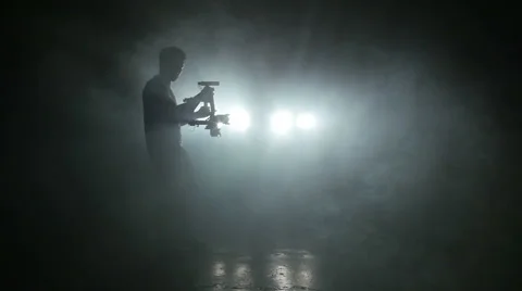 Man operator shoots video with ronin in the spotlight 库存影片 64472534
