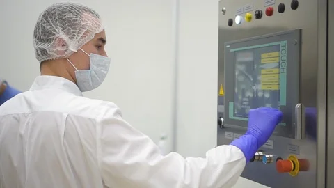 Man operator watch and press on screen during working day in pharmaceutical Stock Footage 121267275