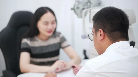 Man optician talking with customer in optical store Stock Footage 195142002