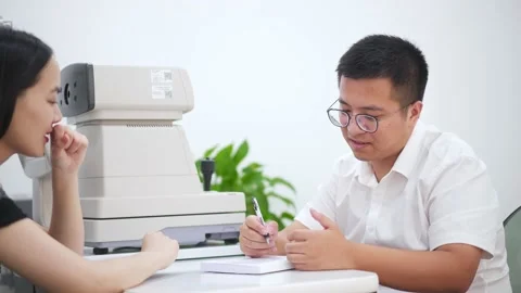 Man optician talking with customer in optical store Stock Footage 195142383