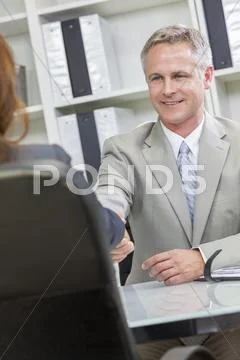 Man or businessman office handshake female colleague Stock Photos