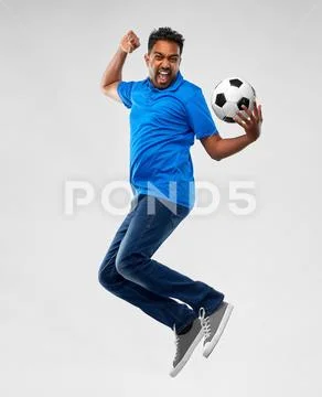 Man or football fan with soccer ball jumping Stock Photos