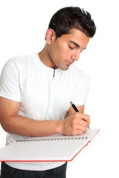 Man or student writes in a notebook Stock Photos