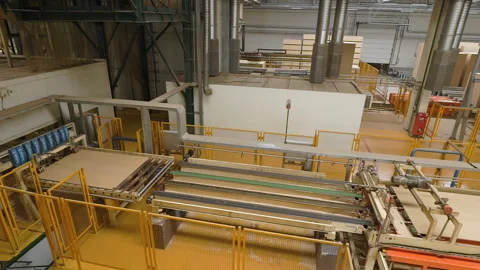 Man or worker controls manufacture or production of fiberboard, particleboard Stock-Footage 107826455