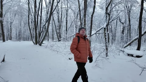 Man In Orange Jacket Walking In Snowy Winter Forest Stock Footage 332337310
