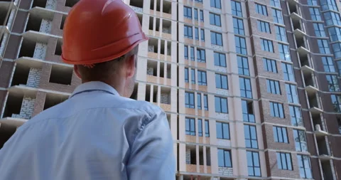 A man in an orange protective helmet Stockbeeldmateriaal 144890158