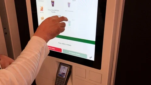 Man ordering fast food in self-service touchscreen kiosk Stock Footage 107149011
