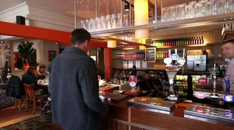 Man ordering pint of beer in pub 스톡 동영상 21032188
