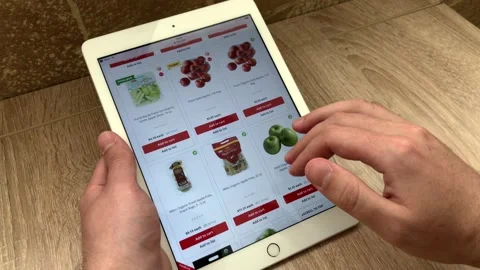 A man orders apples in an online store using a tablet. The choice of products in Stock Footage 131659743