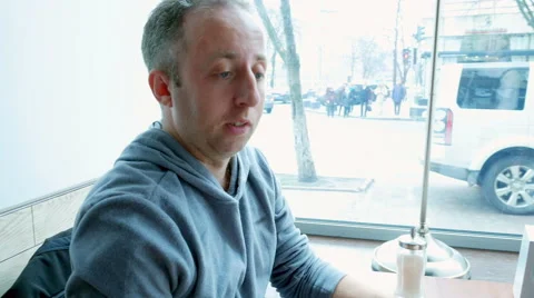 Man orders in a cafe restaurant and texting mobile Stock Footage 62261950