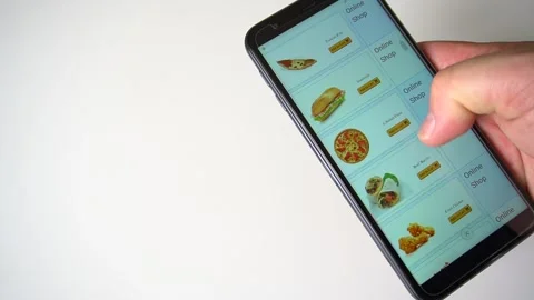 A man orders food online using a smartphone. Stock Footage 135427766