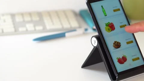 Man Orders Food or Vegetable Office In An Online Store Using A Smartphone. Stockbeeldmateriaal 145684686