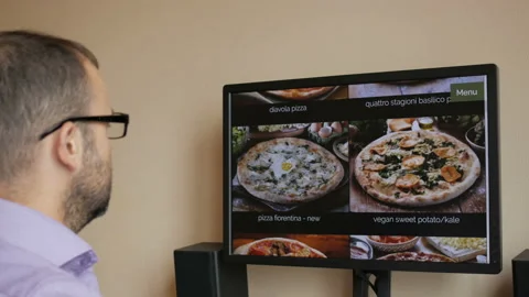 A man orders pizza online on a computer at home. A businessman makes an order Stock Footage 92429721