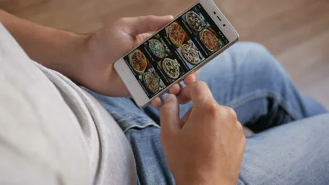 Man Orders Pizza Using Online Delivery Service With Smartphone. Close Up. 4K Stock-Footage 96008652