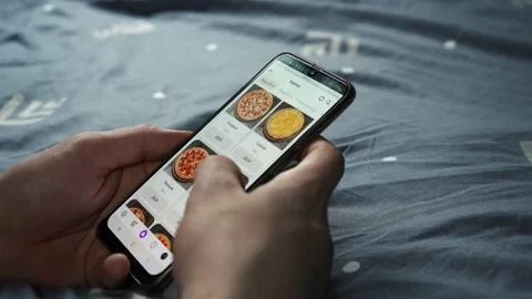 A man orders pizza while lying on the couch. Moscow Russia 20 July 2021 Stock Footage 157902547