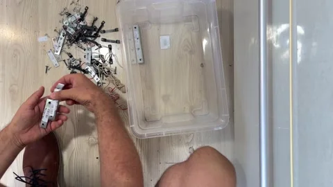 Man organizes different things in a box, top view, sound Stock Footage 331920412