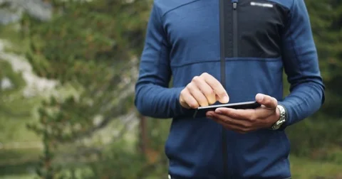 Man orienting by using GPS maps technology on smartphone. Group of friends Stock-Footage 76452052