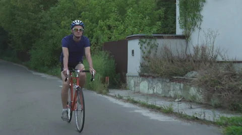A man out for a walk in the park biking Stock Footage 68043221
