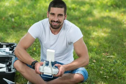 Man Outdoors With Remote Control Preparing the Drone Stock Photos