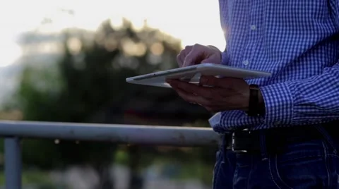 Man outdoors is using of the tablet Stock Footage 63863983