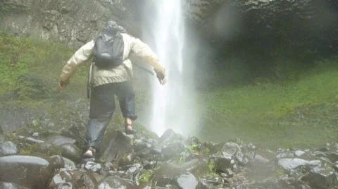 Man Outdoors at Waterfall Stock Footage 874837