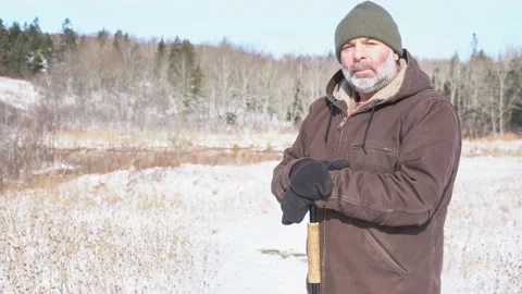 A man outside in the winter with a serious expression. Stock Footage 231406160