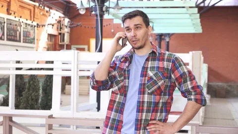 Man over 30 years old talking on the phone city landscape Video stock 88555896