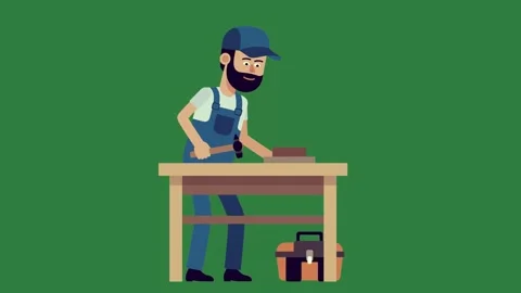 A man in overalls and working on table sitting at desk with laptop beard is Stock Footage 337340533
