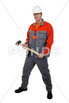 Man in overalls with a hammer in his hands Stock Photos