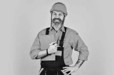 Man in overalls. Structural plan safety. work operation concept. looking project Stock Photos