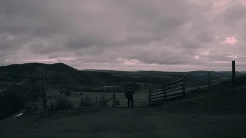 Man overlooking dull colourless British countryside landscape, grim weather Stock Footage 327325186
