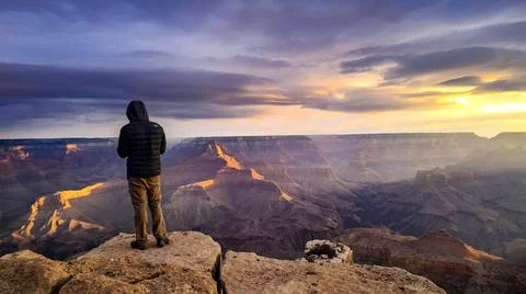 Man Overlooking the Grand Canyon at Sunrise Stock Photos