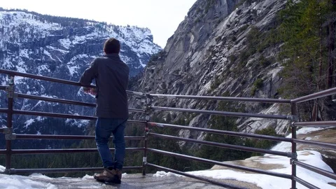 Man Overlooking Top of Waterfall in the Snow 스톡 동영상 87853161