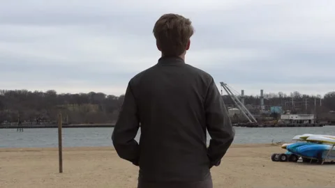 Man overlooking the Waterfront factory Video stock 135821096