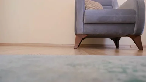 Man pace up and down on wooden floor in front of vintage seat Stock Footage 151049117
