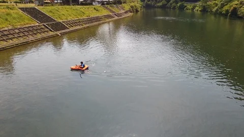 A man is pack rafting in Abu river in Japan ,aerial Stock Footage 108043909