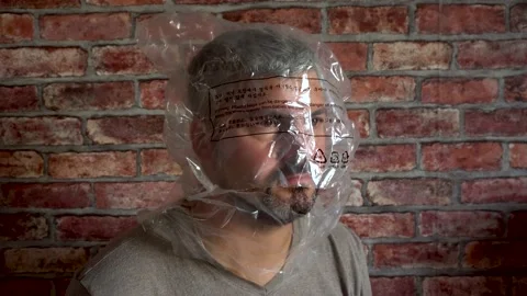 Man with a package on his head against the wall 4K Stock Footage 160119461