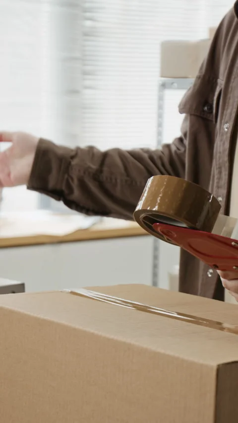 Man Packing Cardboard Box for E-commerce Order Delivery Stock Footage 342602752