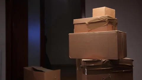 Man packing cardboard boxes preparing for home relocation Video stock 318980536