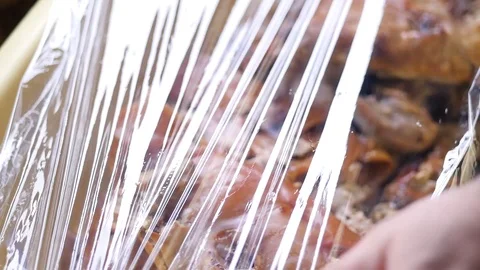 Man packing cut meat in foil Stock Footage 88828133