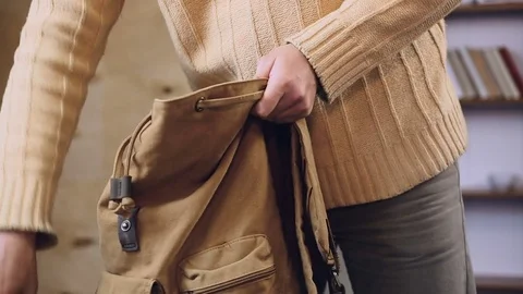 Man packing his touristic backpack with favorite clothes, preparing for journey Stock Footage 79988033