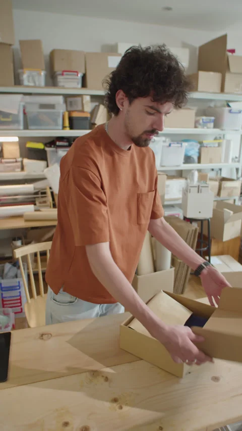 Man Packing Order into Parcel Box in Online Store Warehouse Stock Footage 238690473