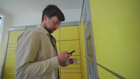 Man at packing station using screen and holding box for self shipment. Parcel Stock Footage 242792122